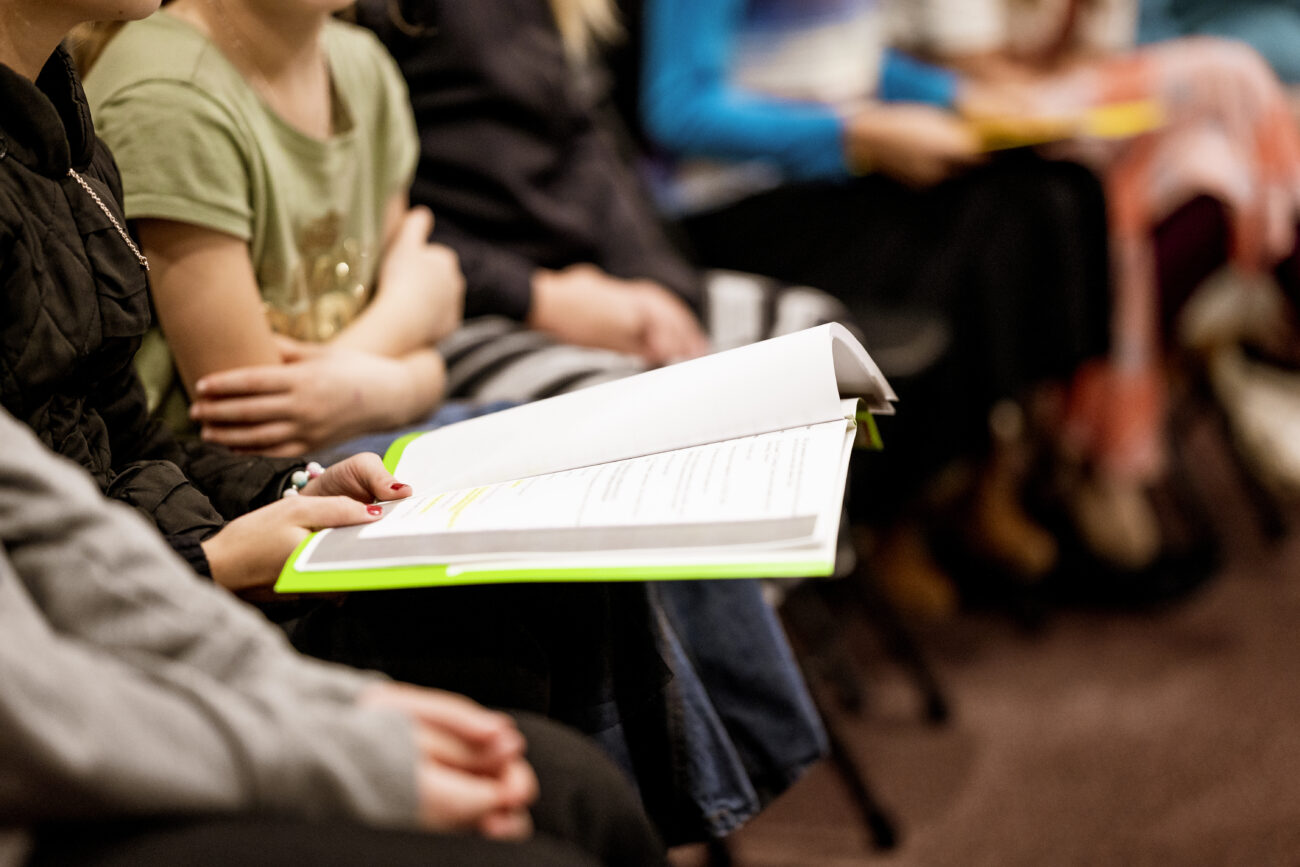 A selective focus shot of a person holding a book